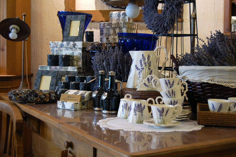 Lavender-themed tea set, dried flowers, and decorative boxes displayed on a wooden table